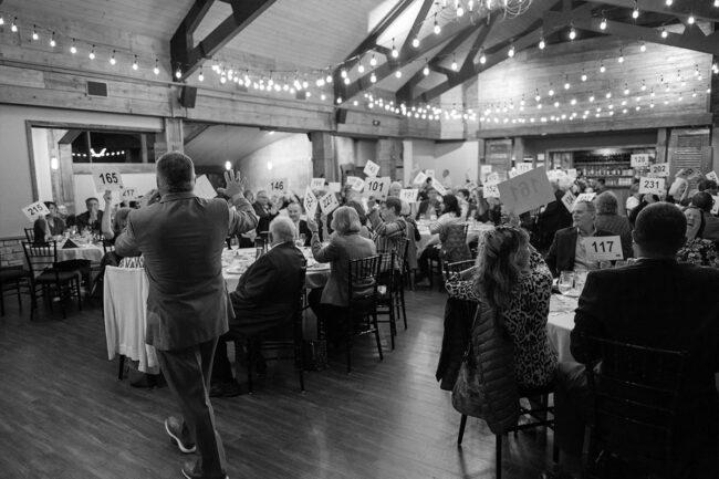 Auctioneer taking numbers at an auction