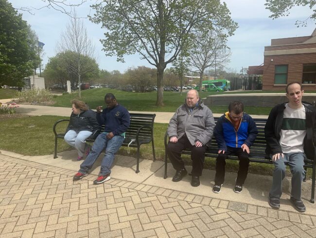 Individuals sitting on benches