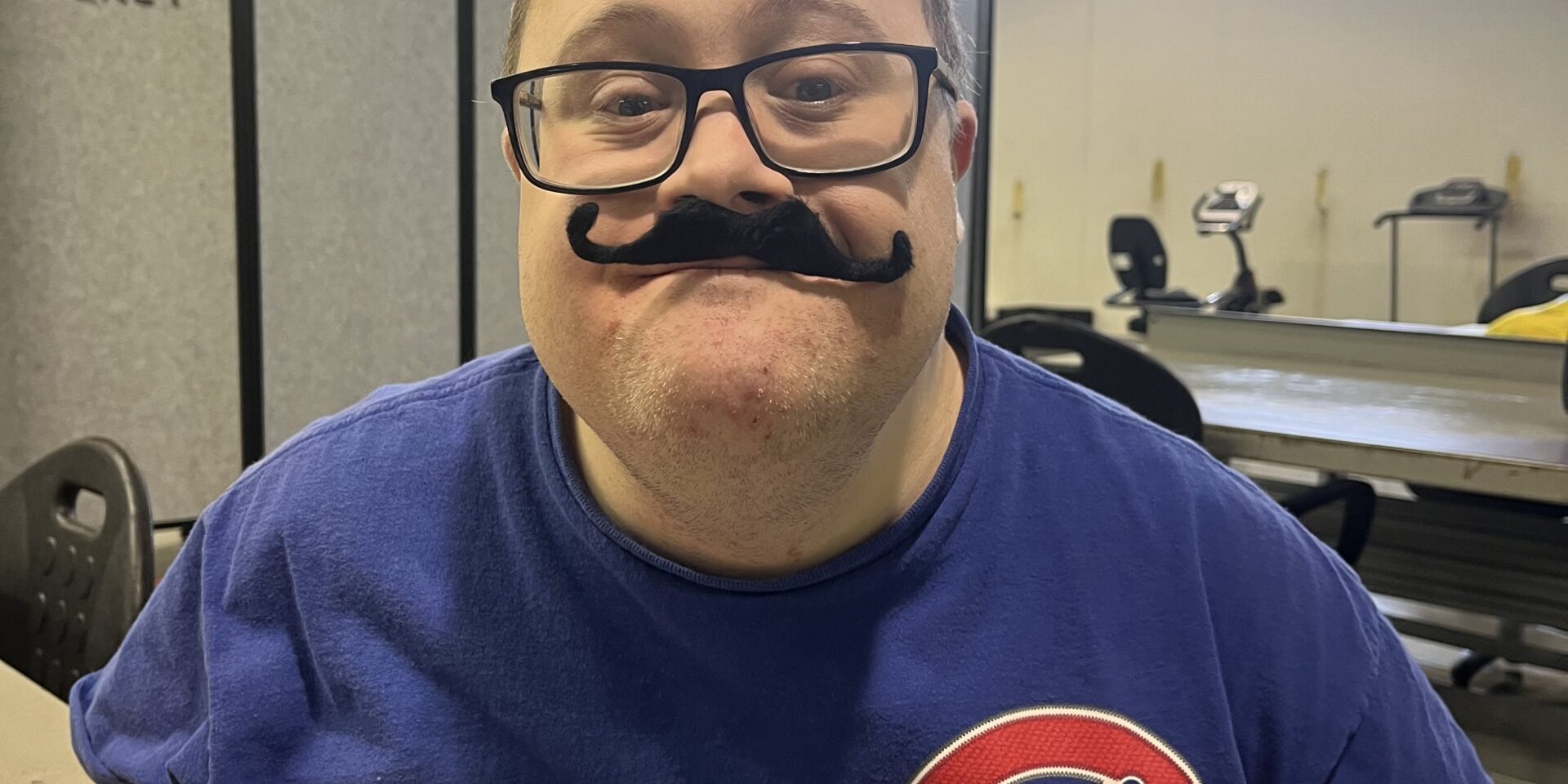 Man posing with a fake moustache