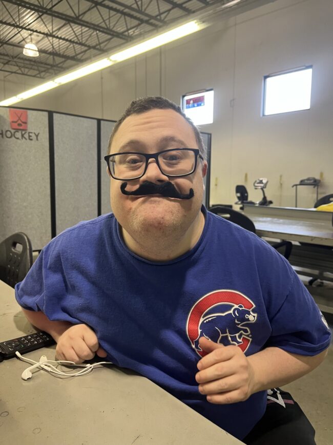 Man posing with a fake moustache