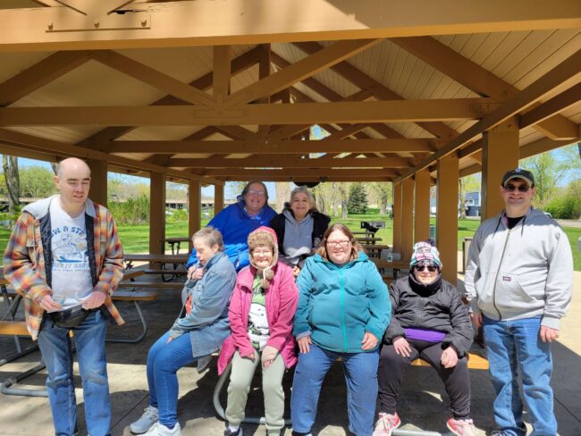 Individuals posing in a park pavilion
