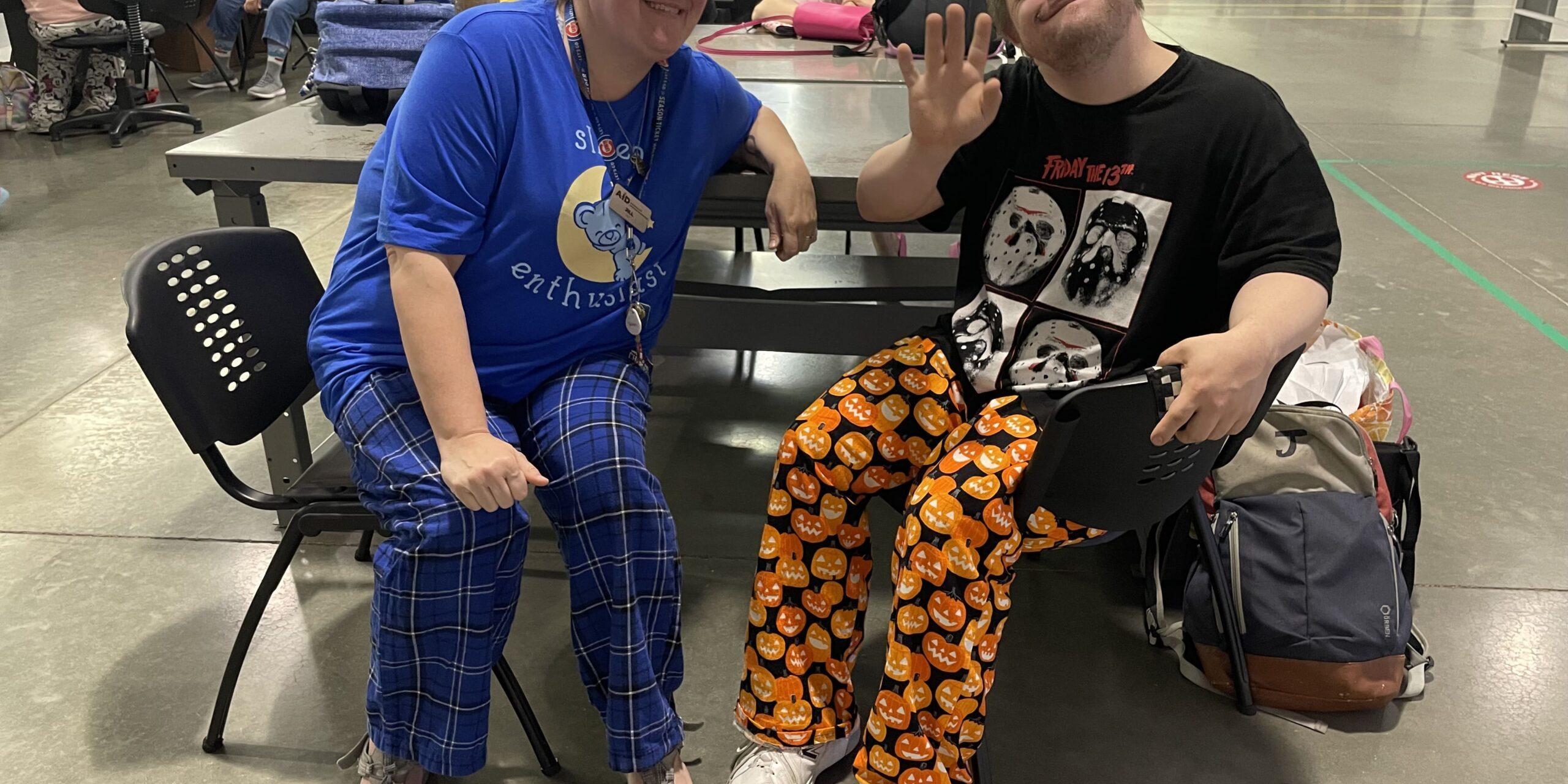 Two individuals in pajamas posing for a picture