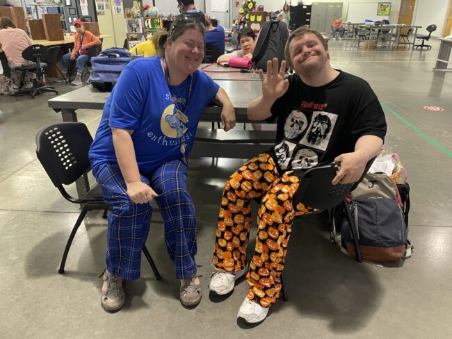 Two individuals in pajamas posing for a picture