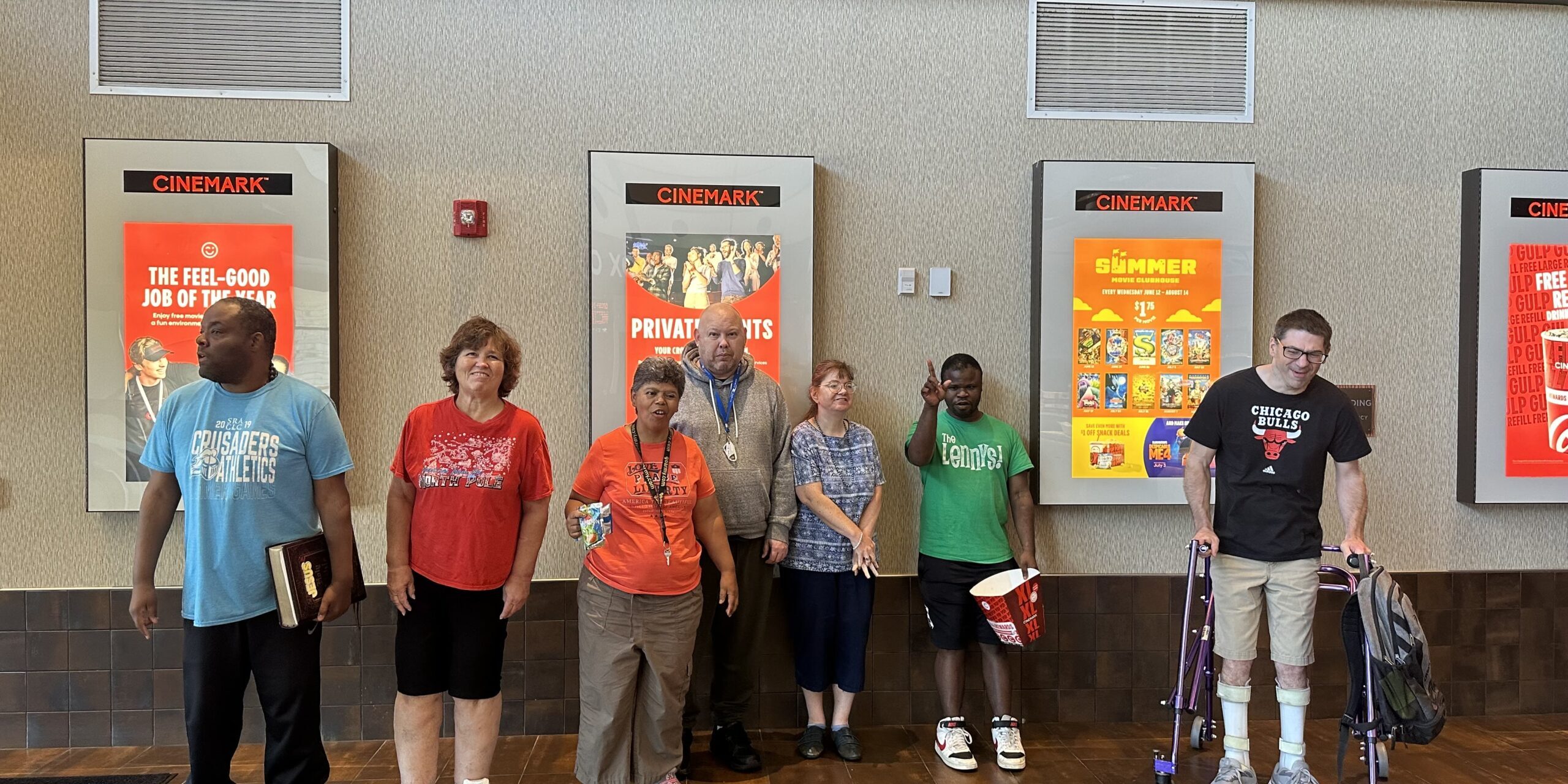 A group of individuals posing at a Movie Theater