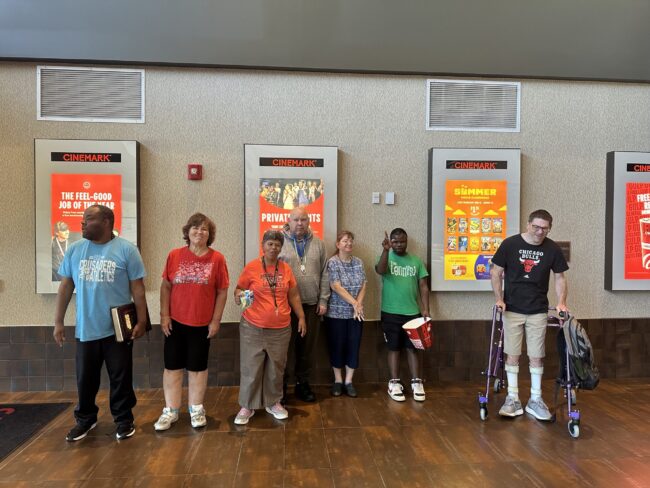 A group of individuals posing at a Movie Theater