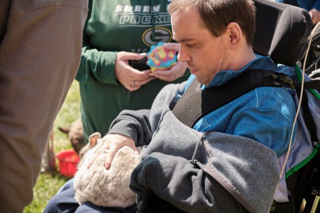 Man in a wheelchair with a bunny on his lap