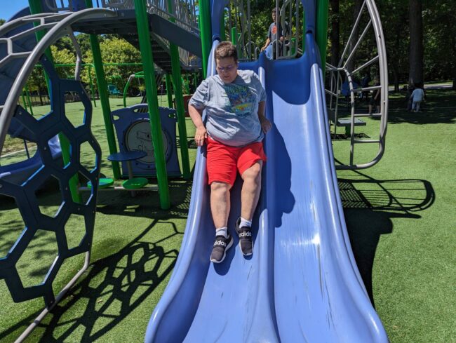 Individual sliding down a slide