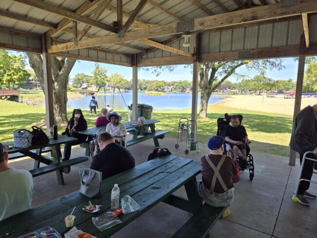 Individuals having lunch in a pavillion