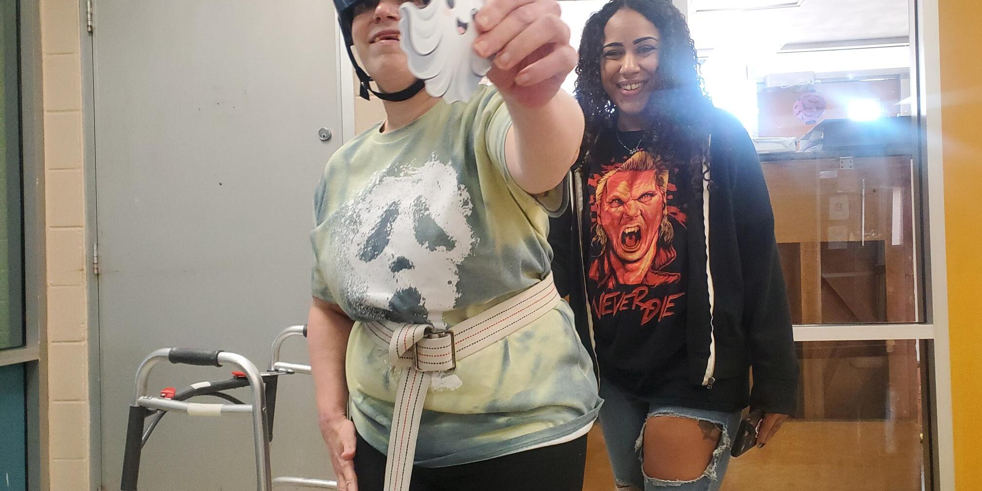 Individual showing off a cute paper ghost at a Halloween Party