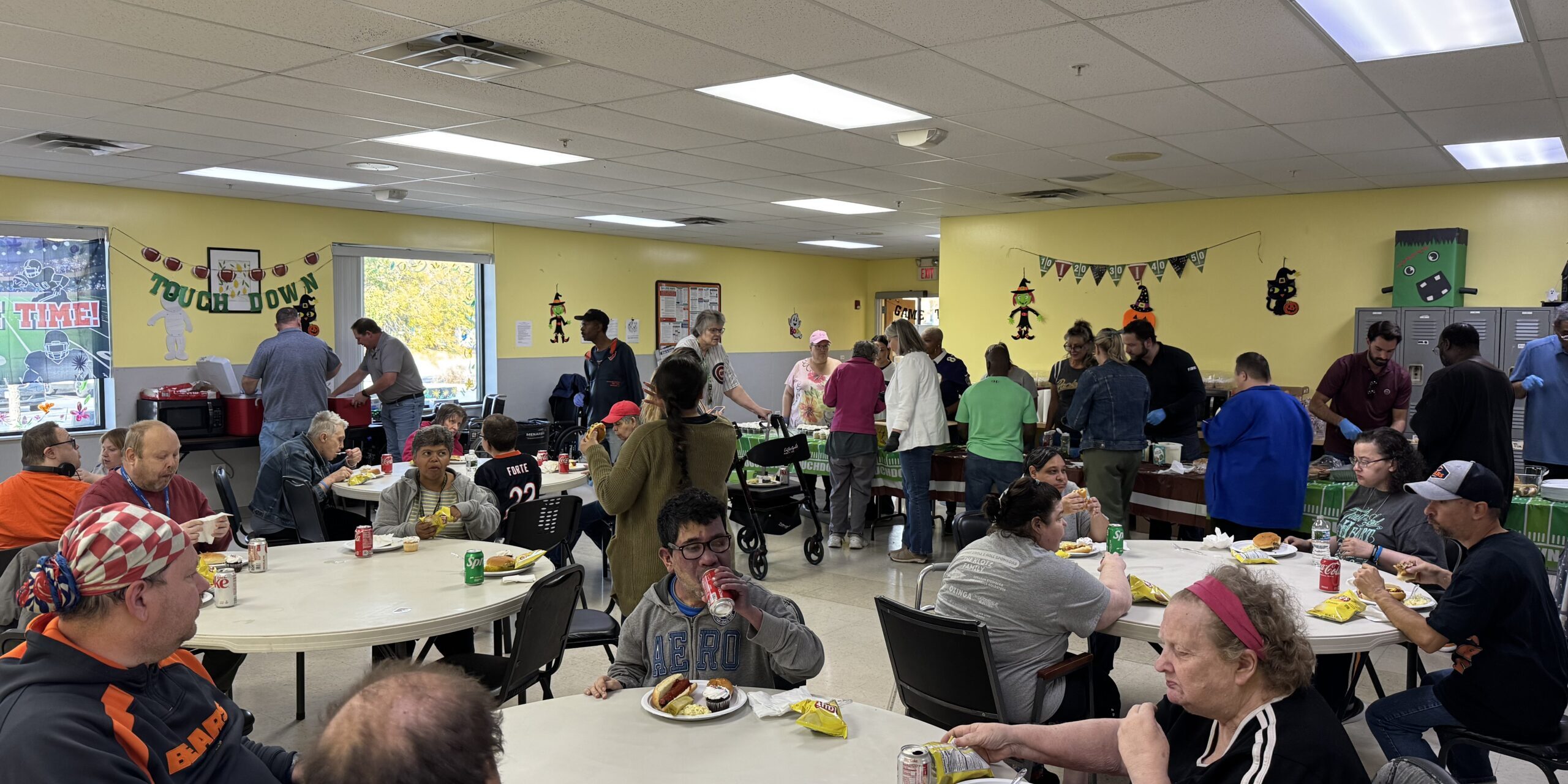 Individuals eating and dancing at a football-themed party