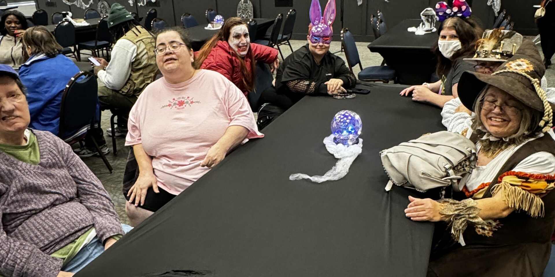 Individuals posing at a Halloween party