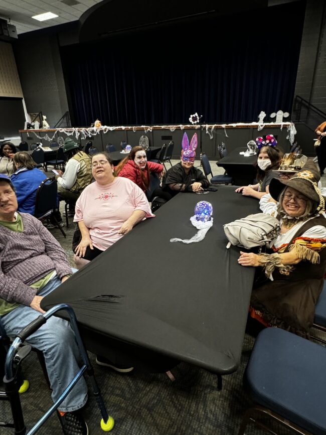 Individuals posing at a Halloween party