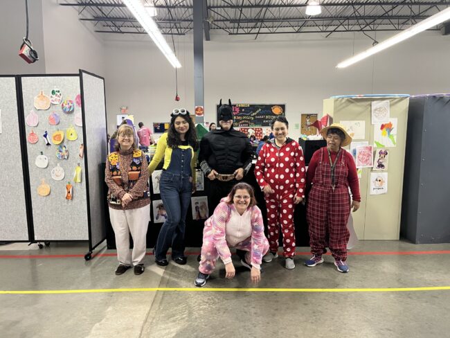 Individuals in Halloween Costumes posing for a picture