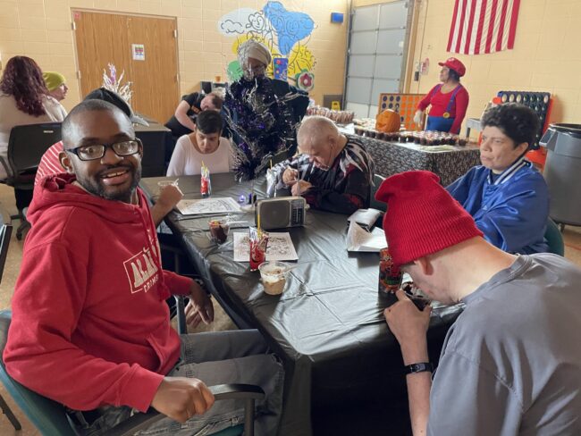 Individuals posing for a picture at a Halloween Party
