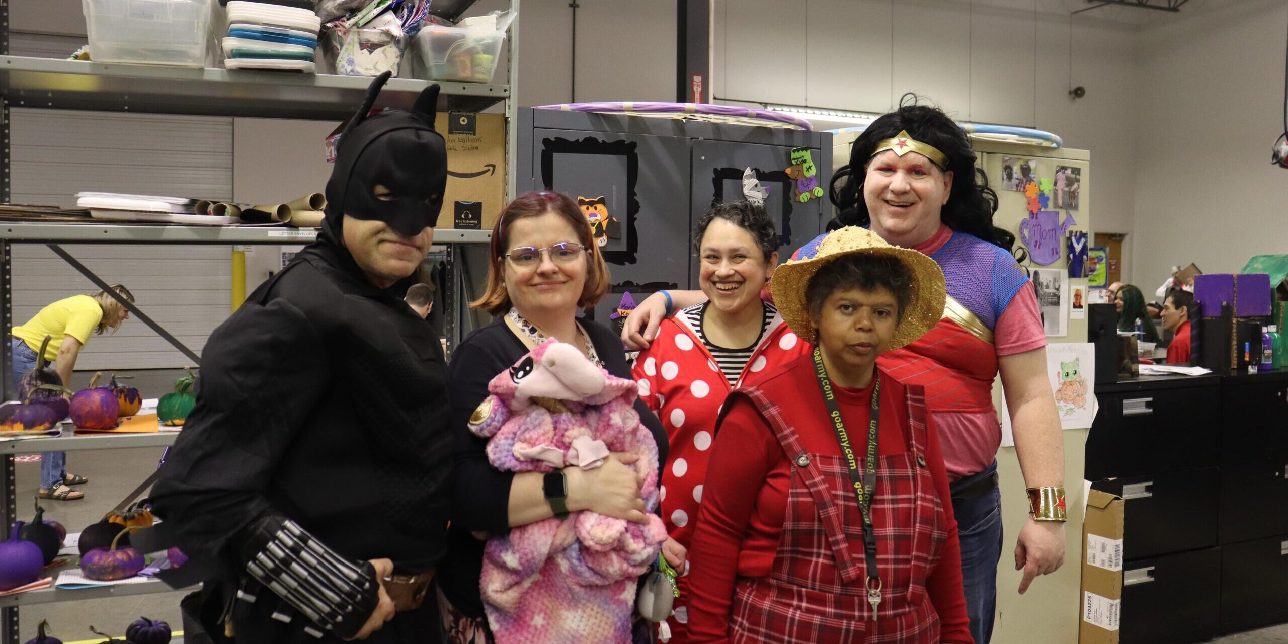 Individuals in costumes posing for a picture