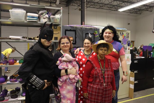 Individuals in costumes posing for a picture