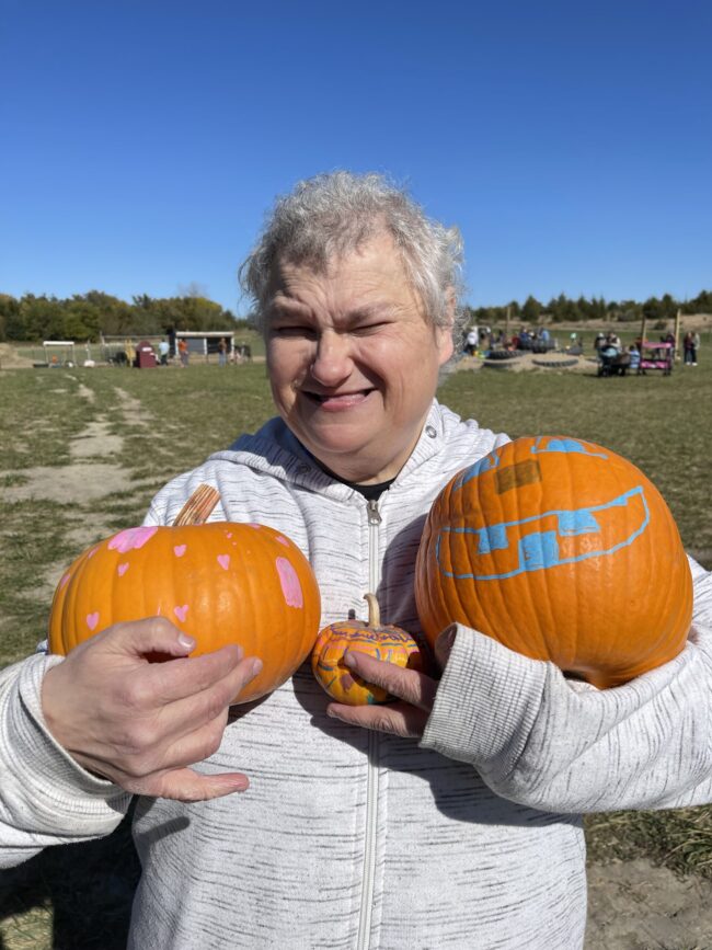 IMG_9951 Individual holding three painted pumpkins