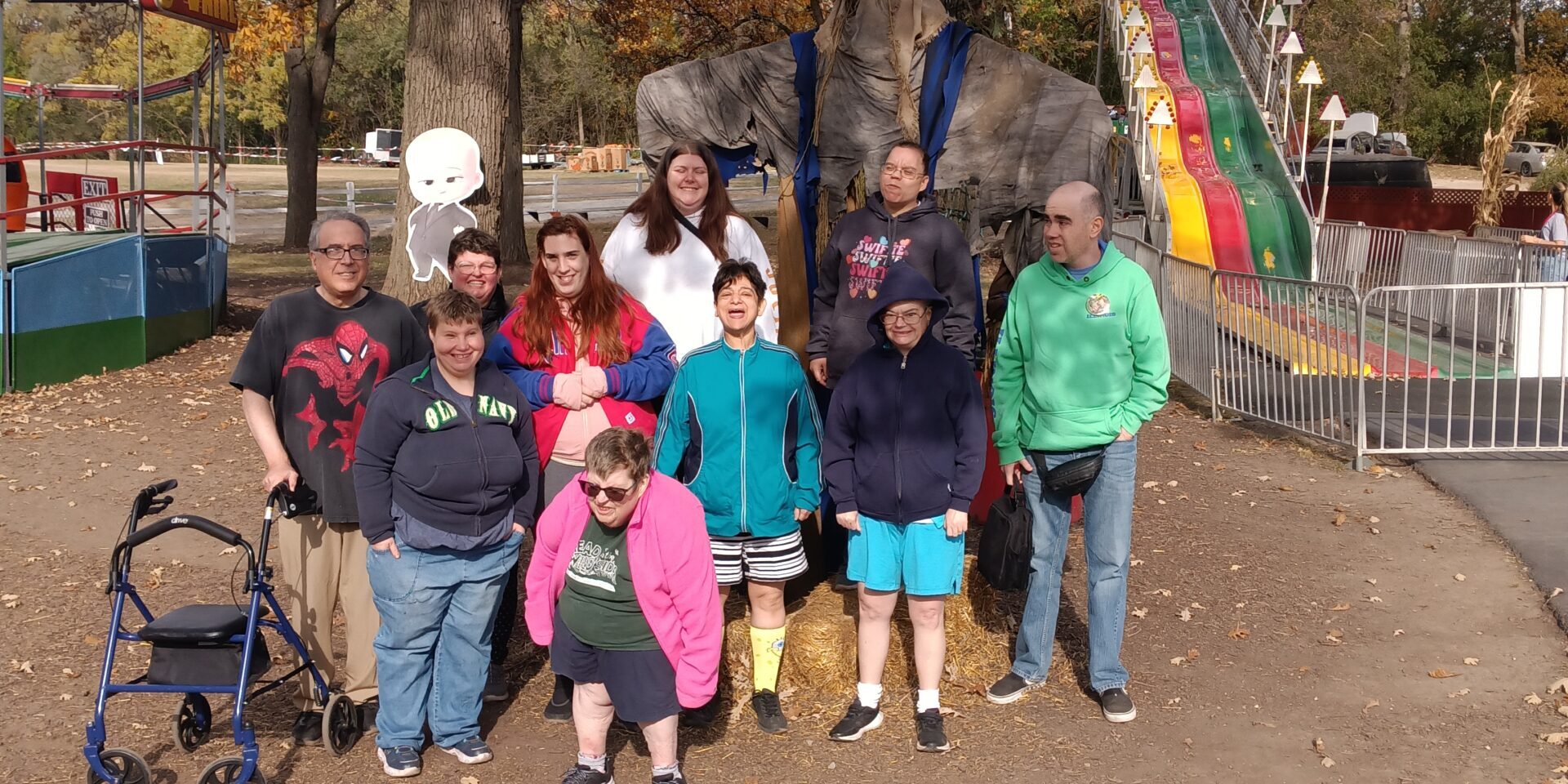 Individuals posing for a photo at a fall-themed carnival