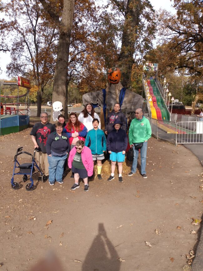 Sonny Acreas Group Individuals posing for a photo at a fall-themed carnival