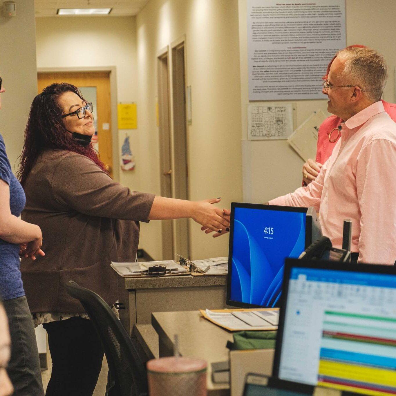 Man shaking hands with woman