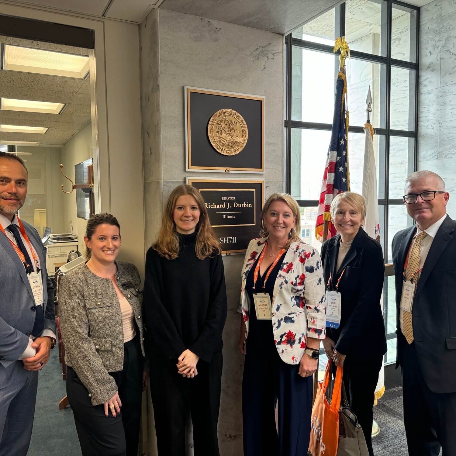 Six individuals smiling at the Illinois state capital