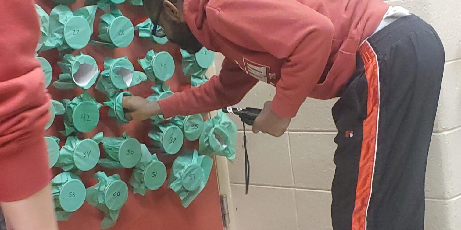 Man reaches into a Grinch Grab cup