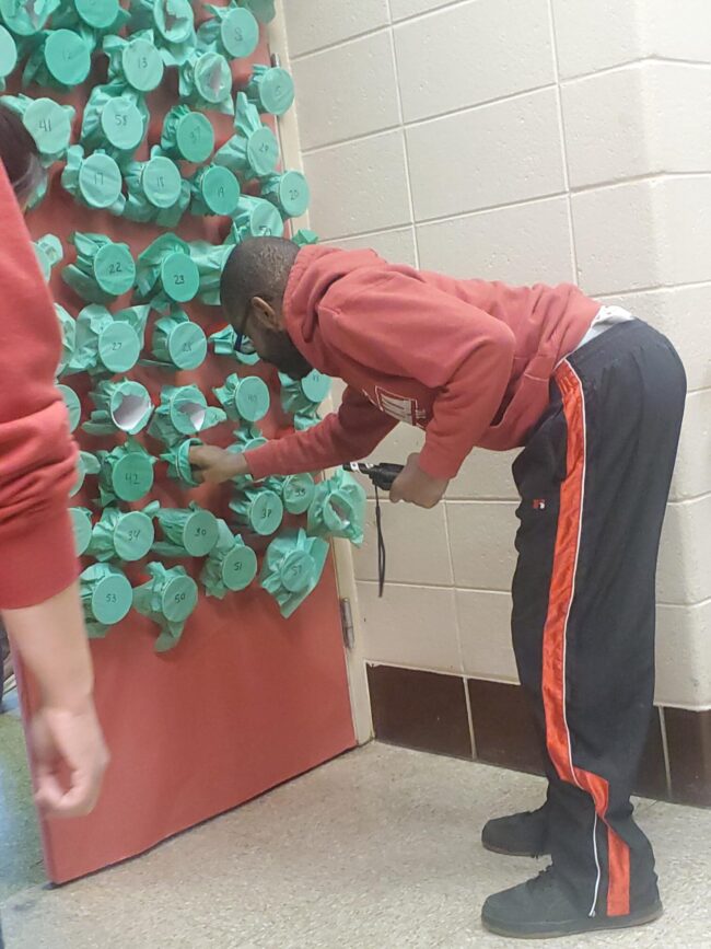 Man reaches into a Grinch Grab cup