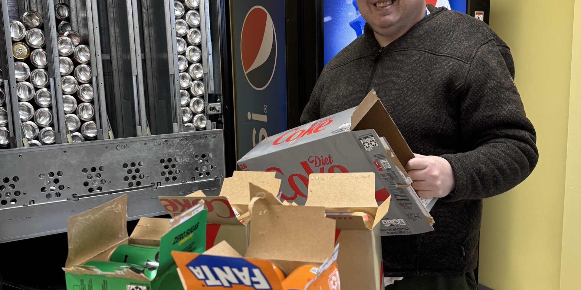 Man restocking pop machine