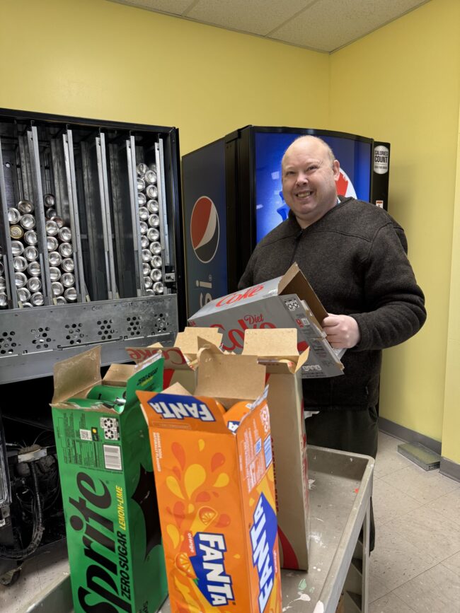 Man restocking pop machine